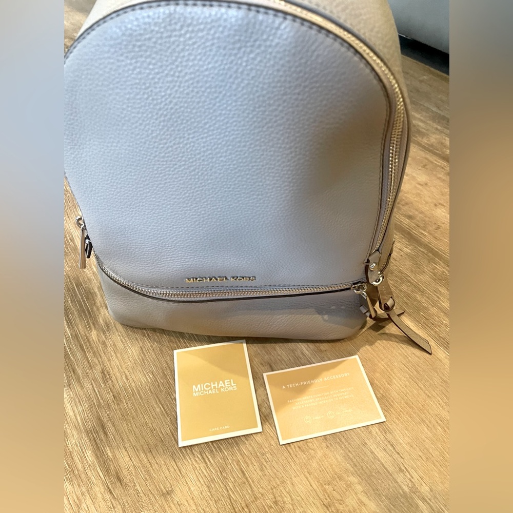 Michael Kors Small Rhea Zip Leather Backpack.
Color: Pearl Gray/Silver hardware